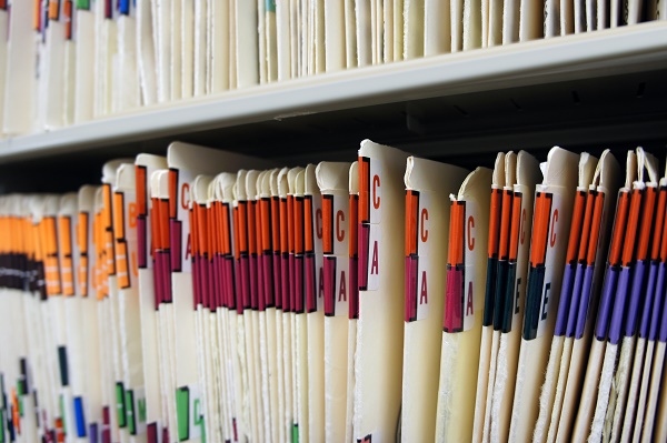 Medical records in file cabinet at doctor's office.